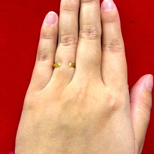 Gold ring with some rhinestone at the tip